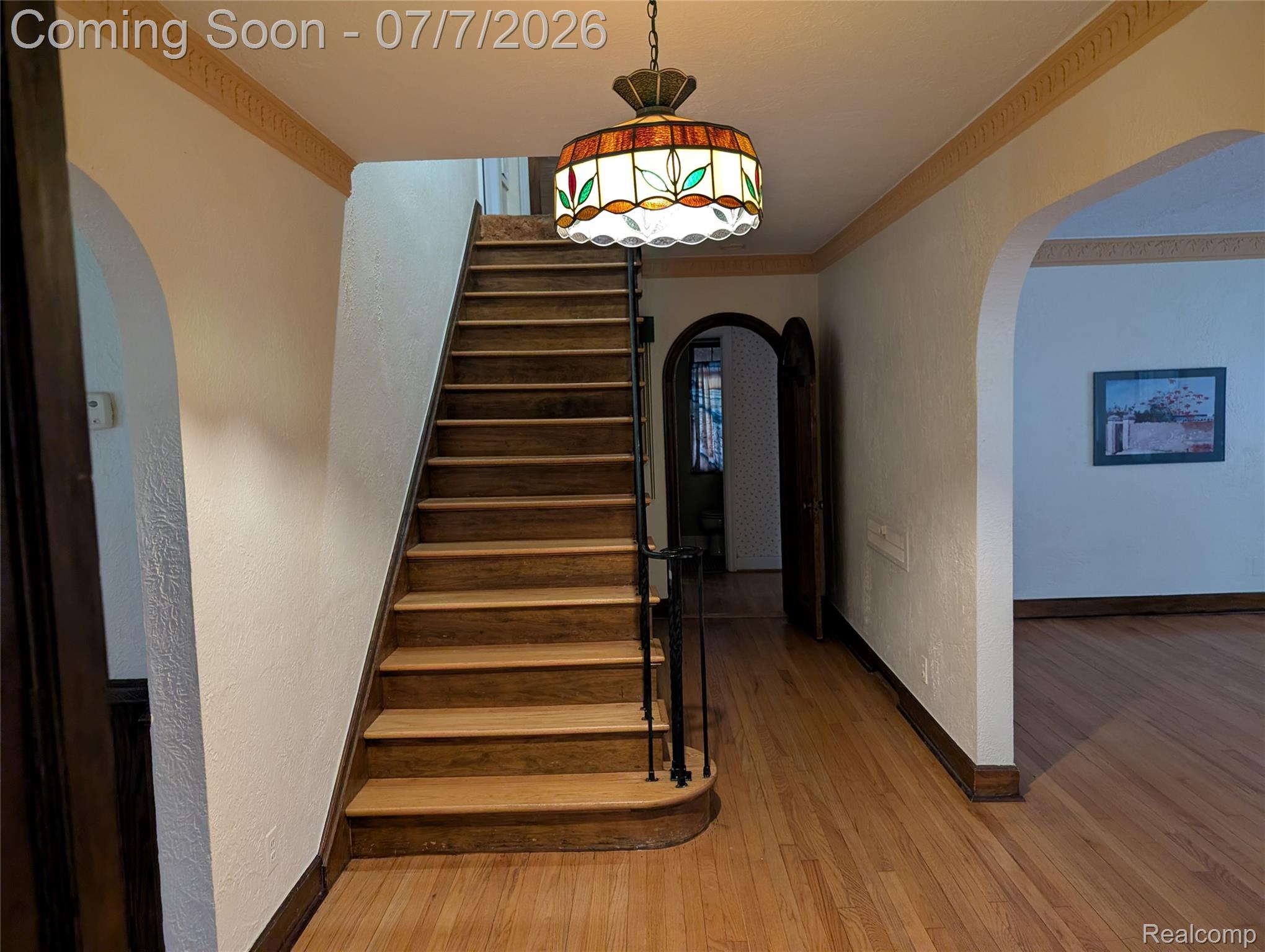 16580 Westmoreland Road Detroit, MI 48219 - Photo 4 of 37 Entry and staircase complemented by Tiffany stained-glass pendant light fixture