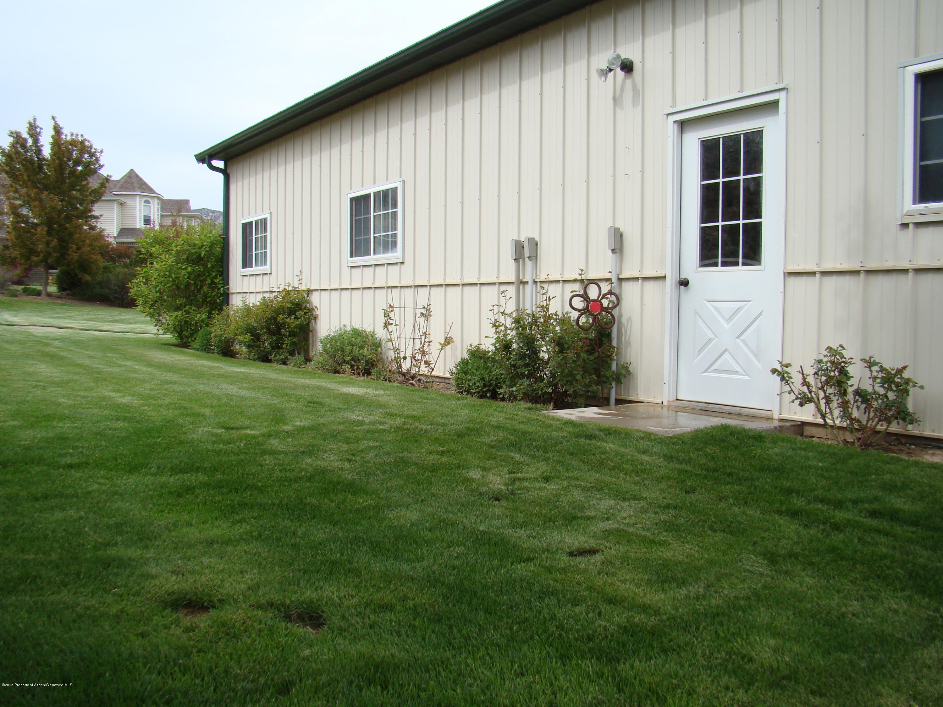 3143 County Road 233 Rifle, CO 81650 - Photo 17 of 36 a front view of a house with garden