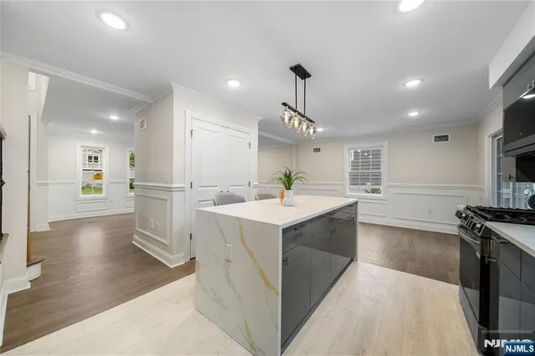 a kitchen with a sink stainless steel appliances and cabinets