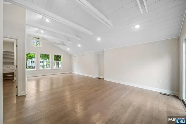 an empty room with windows and entrance