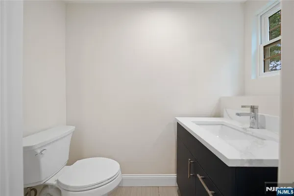 a bathroom with a sink a toilet and vanity