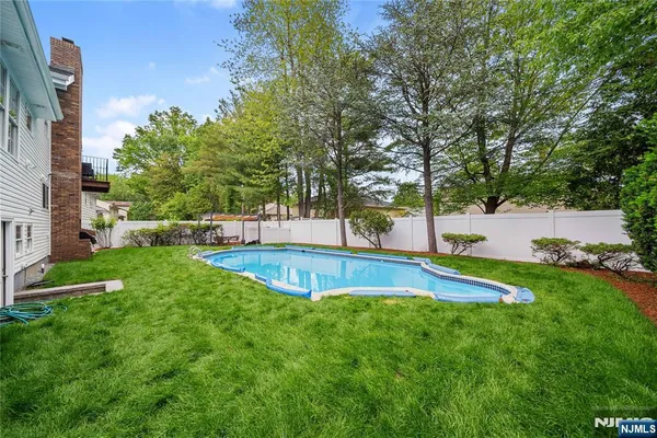 a view of a backyard with large trees
