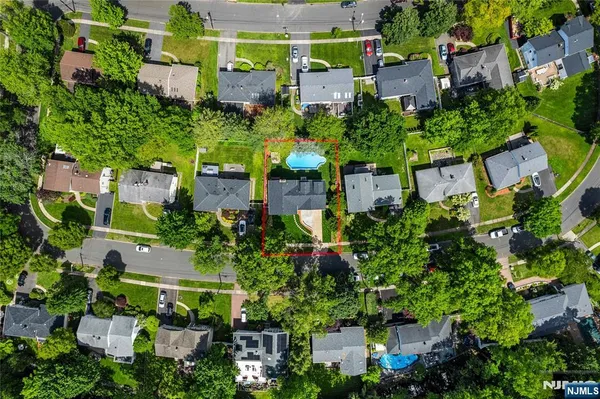 an aerial view of a house with a yard and garden