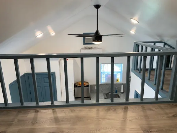 a living room with a bed furniture and a window