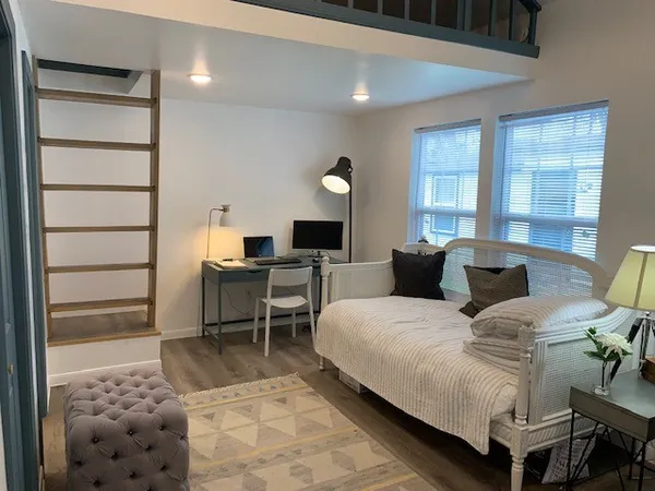 a kitchen with a sink a cabinets and wooden floor