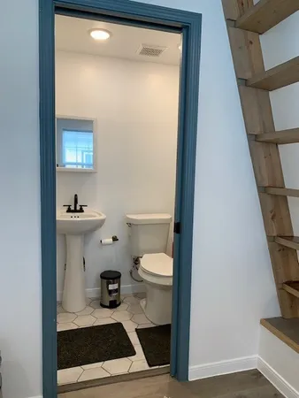 a white toilet sitting next to a bathroom sink