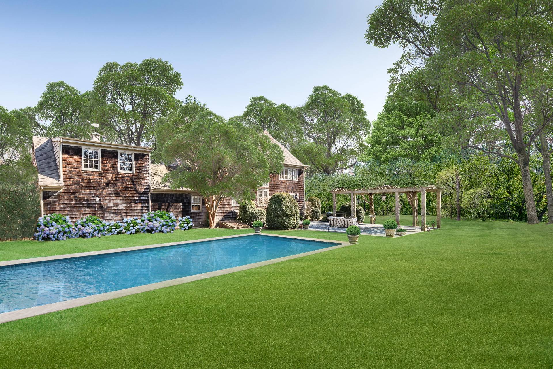 22 Barn Lane Bridgehampton, NY 11932 - Photo 14 of 18 a front view of a house with a yard table and chairs