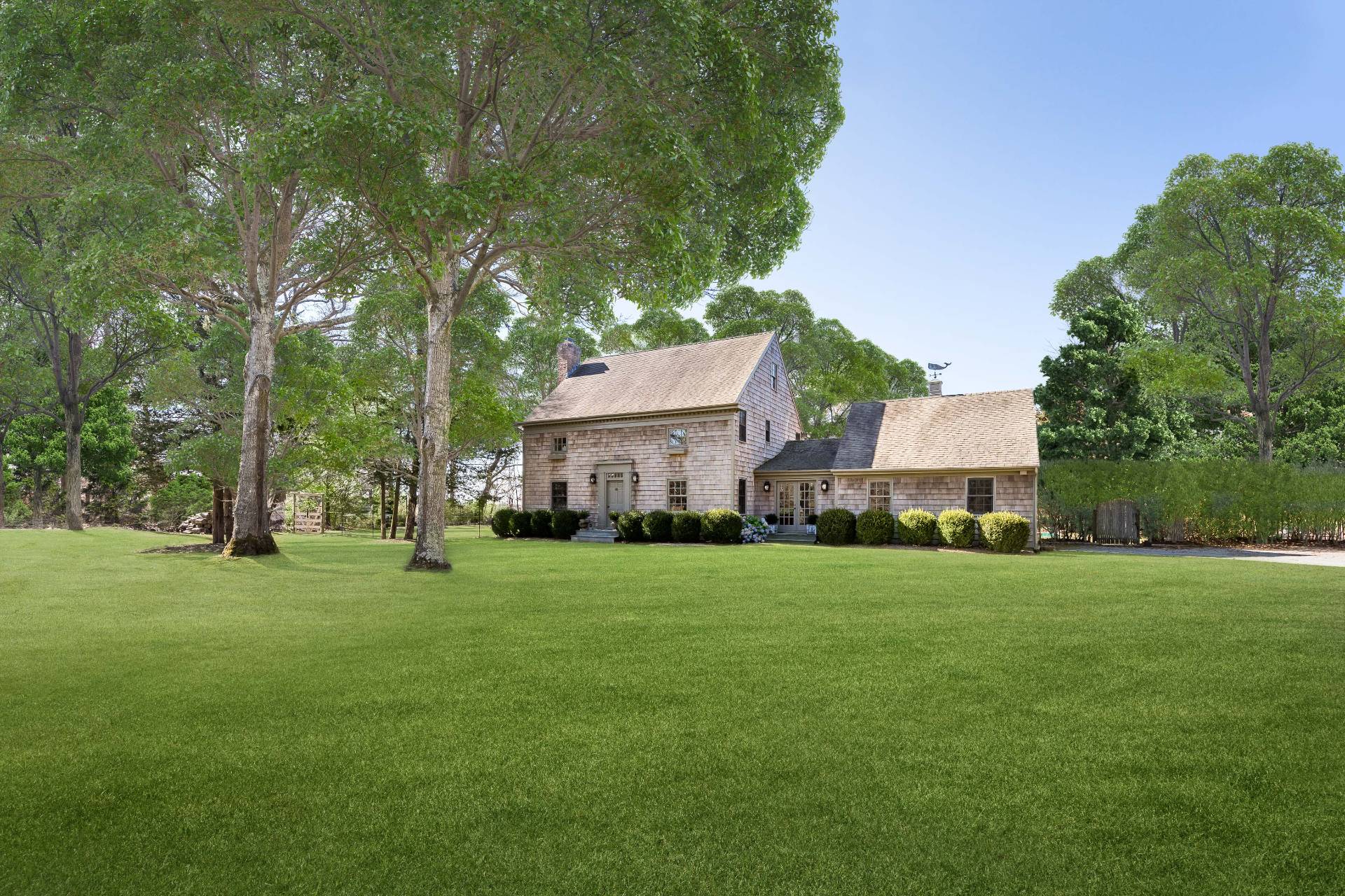 22 Barn Lane Bridgehampton, NY 11932 - Photo 18 of 18 a front view of a house with a yard and trees