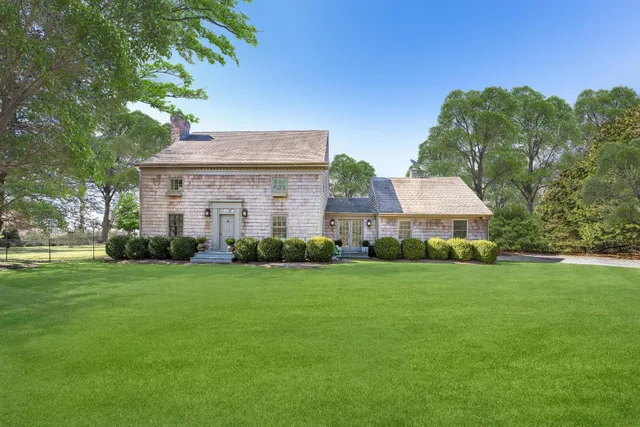 a front view of a house with a garden