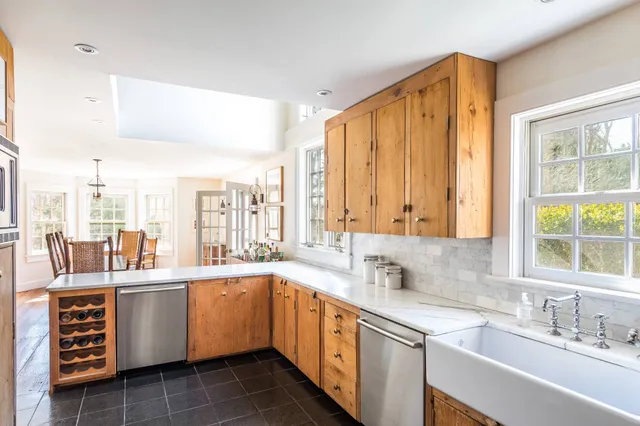 a kitchen with a sink stove and cabinets