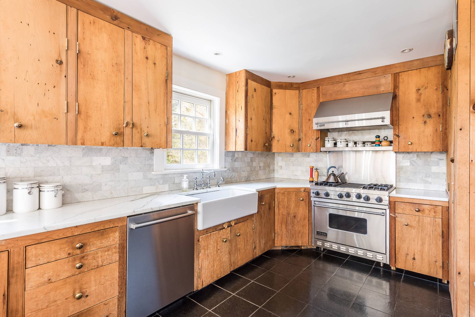 22 Barn Lane Bridgehampton, NY 11932 - Photo 6 of 18 a kitchen with stainless steel appliances a stove a sink and a microwave
