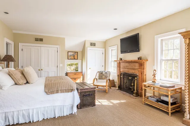 a bedroom with a bed and a fireplace