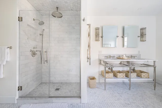 a bathroom with a sink toilet a mirror and shower