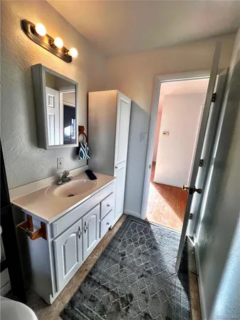 a bathroom with a sink a mirror and a shower