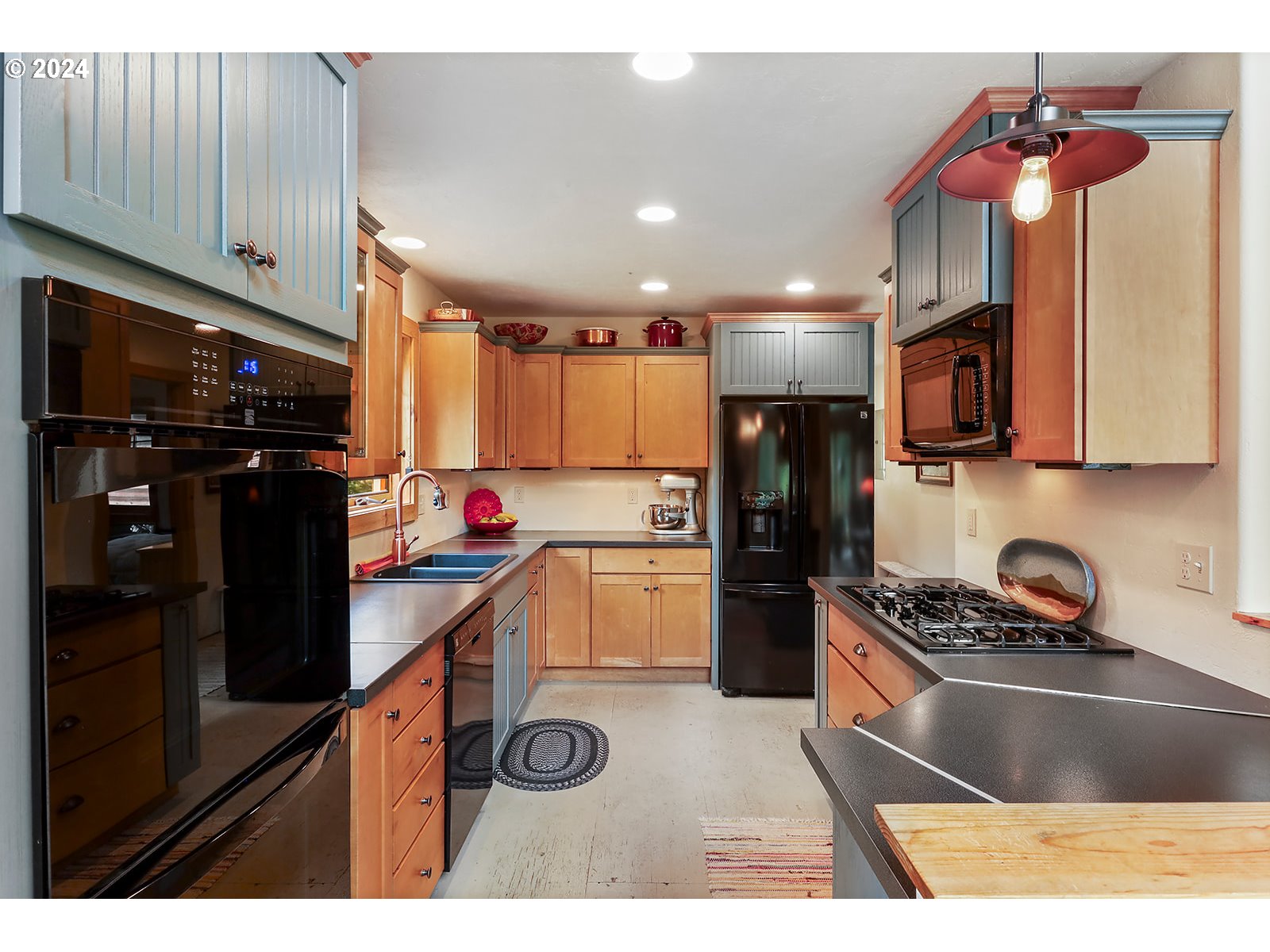 3610 Benton Road Hood River, OR 97031 - Photo 23 of 48 a kitchen with kitchen island granite countertop a refrigerator stove top oven and cabinets