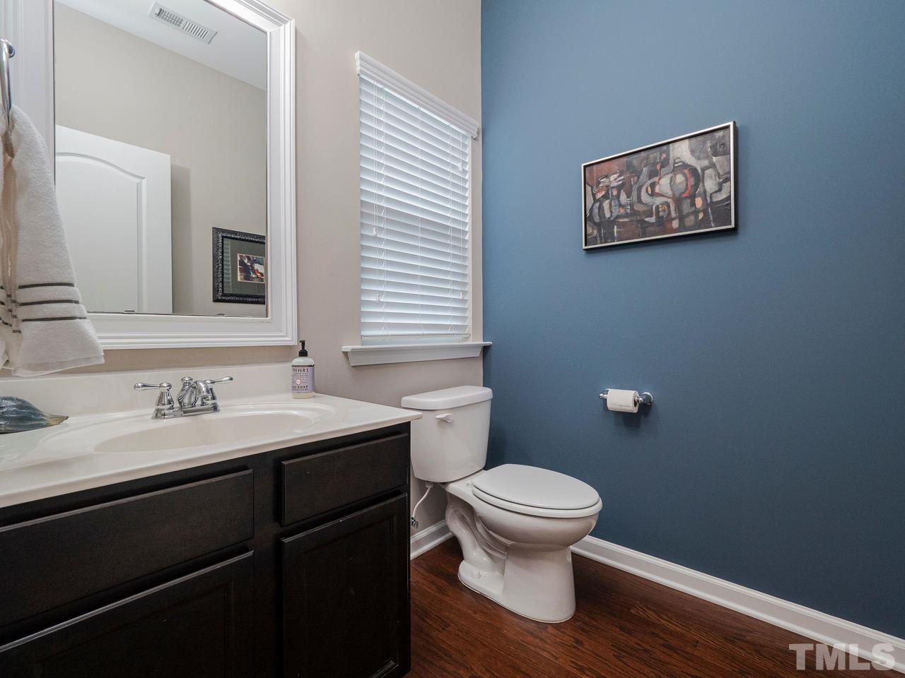 1001 Ileagnes Road Raleigh, NC 27603 - Photo 11 of 26 a bathroom with a toilet sink and mirror