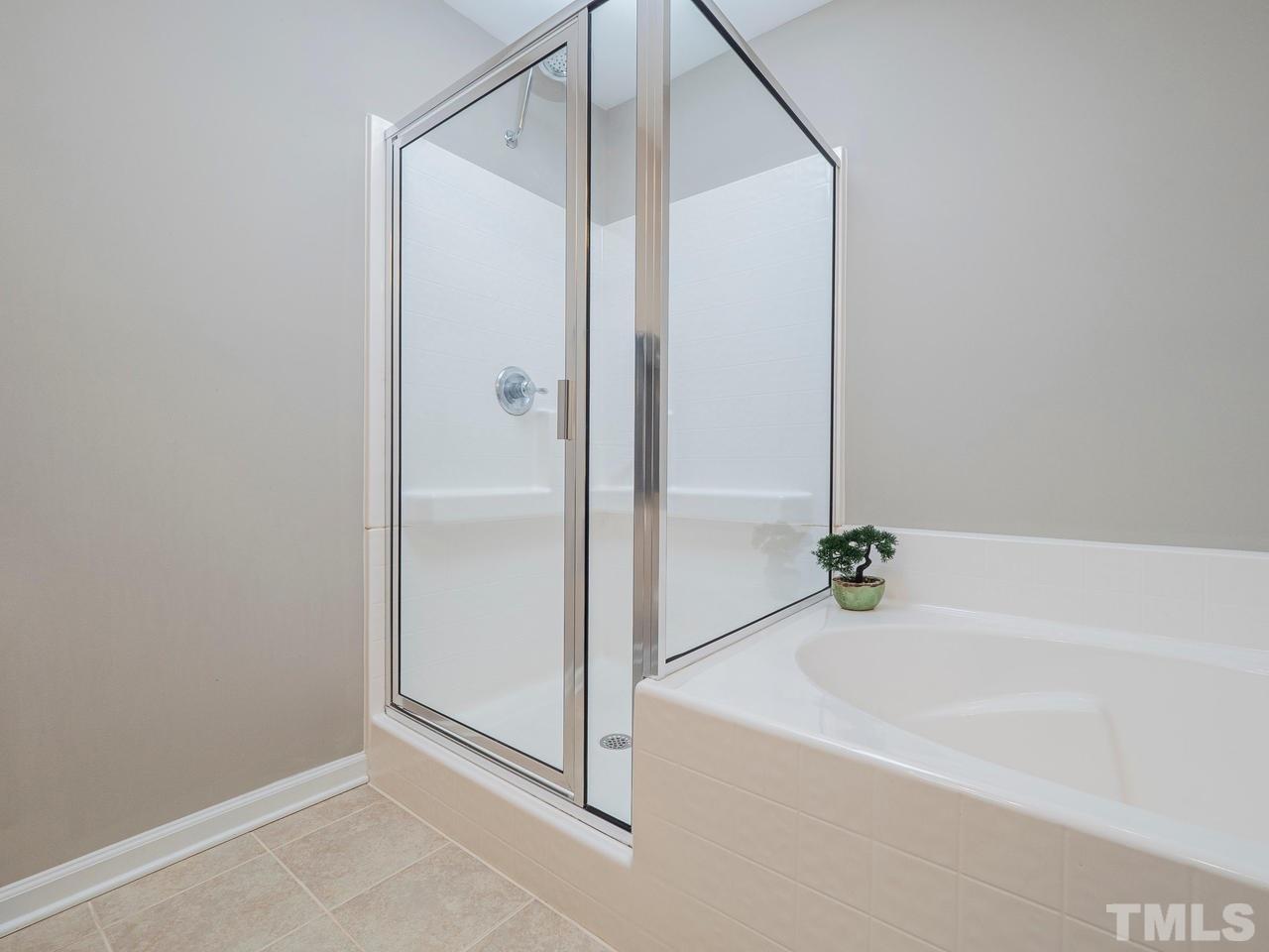 1001 Ileagnes Road Raleigh, NC 27603 - Photo 16 of 26 a bathroom with a bathtub and a shower