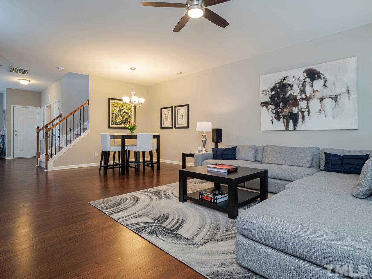 1001 Ileagnes Road Raleigh, NC 27603 - Photo 5 of 26 a living room with furniture a wooden floor and a ceiling fan