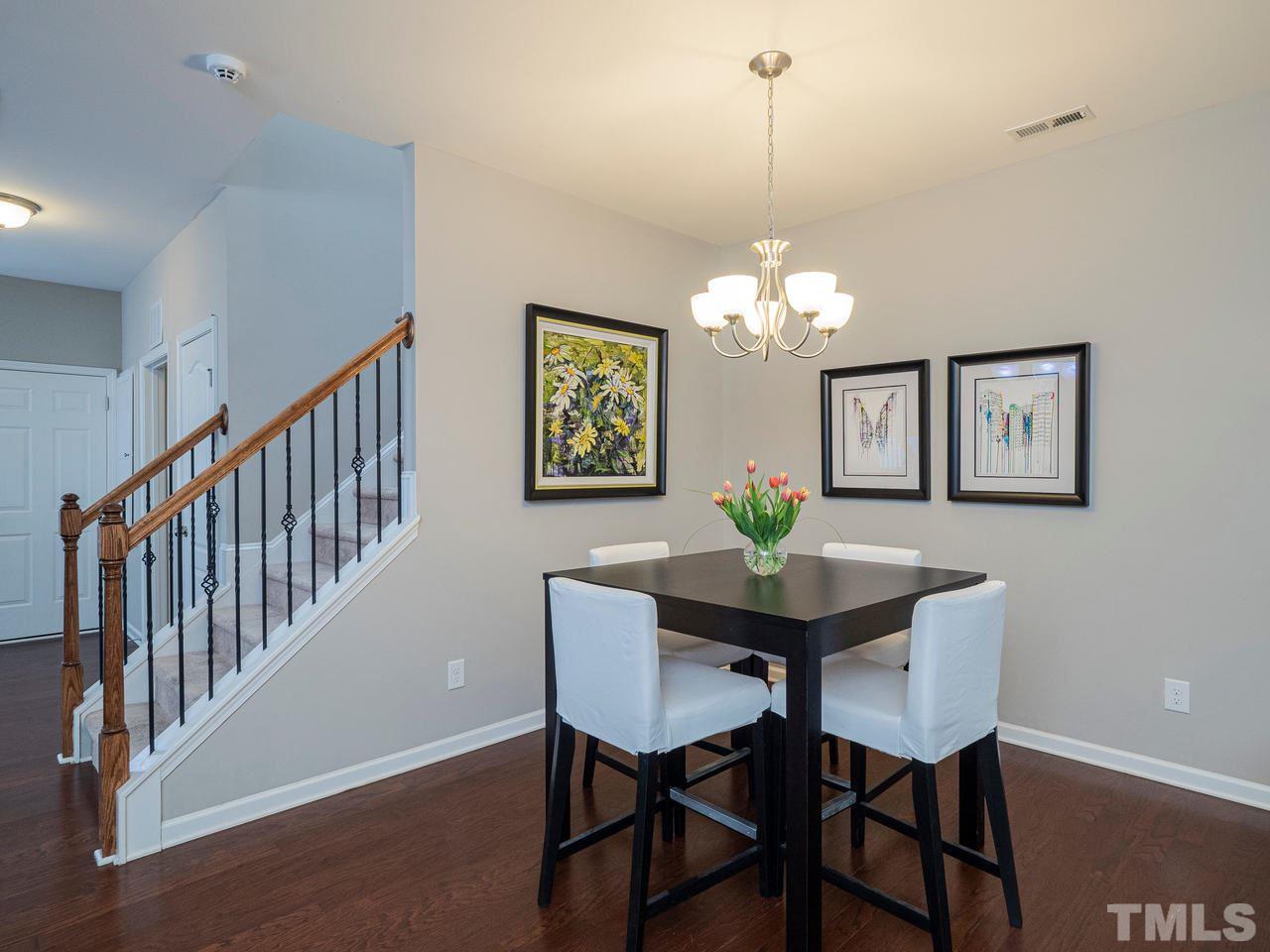 1001 Ileagnes Road Raleigh, NC 27603 - Photo 6 of 26 a dining room with furniture a chandelier and wooden floor