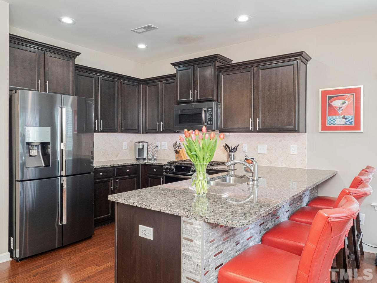 1001 Ileagnes Road Raleigh, NC 27603 - Photo 9 of 26 a kitchen with granite countertop stainless steel appliances and wooden cabinets