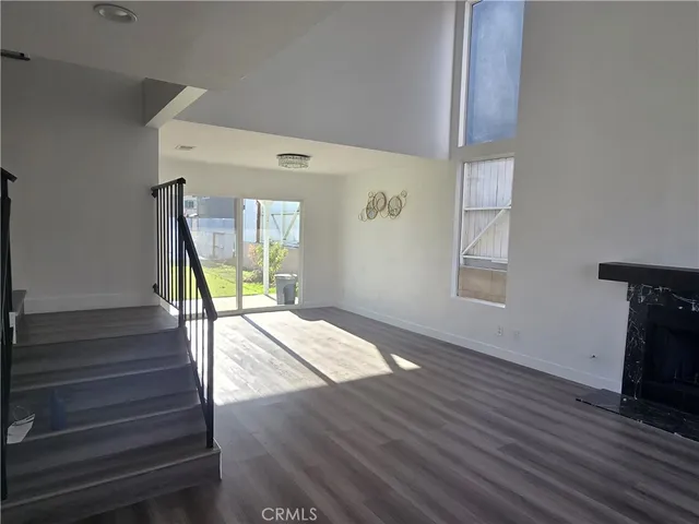 a view of an entryway with wooden floor and a front door
