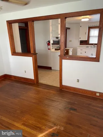 a view of kitchen with stainless steel appliances cabinets and wooden floor