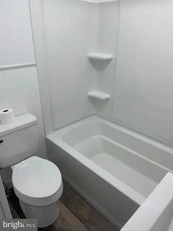 a bathroom with a toilet and a bathtub