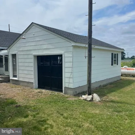 a front view of house with a garden