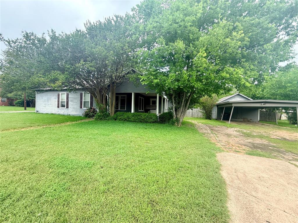 302 West Orville Street Wills Point, TX 75169 - Photo 1 of 1 a front view of a house with a yard and trees