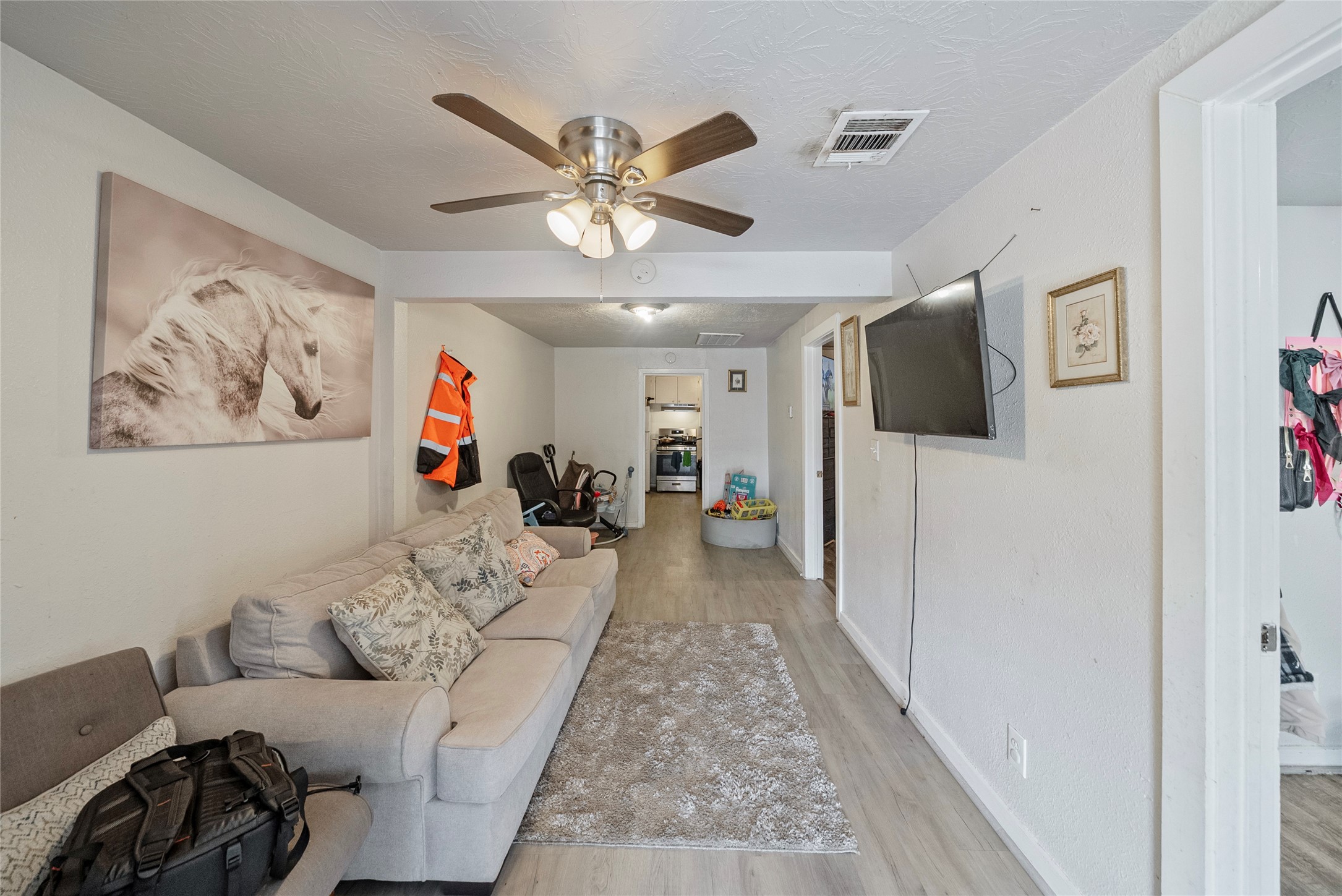 7938 Kerr Street, Unit 6 Houston, TX 77029 - Photo 5 of 18 a living room with furniture and a flat screen tv