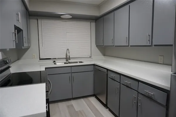 a kitchen with a sink and cabinets