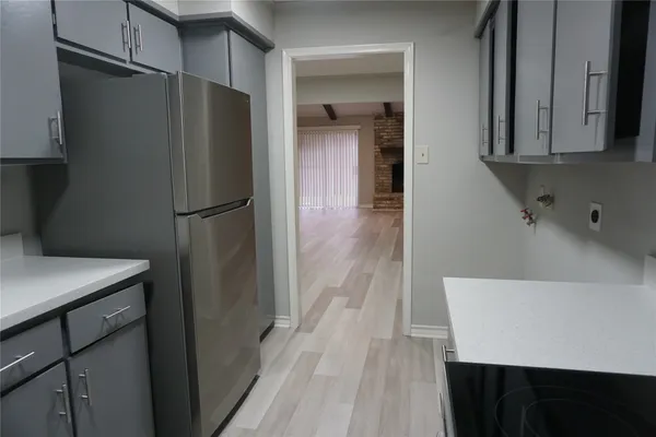 a kitchen with a refrigerator and cabinets