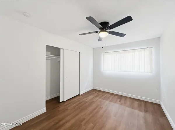 a view of an empty room with wooden floor