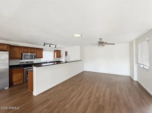 a view of a kitchen with a sink and a refrigerator