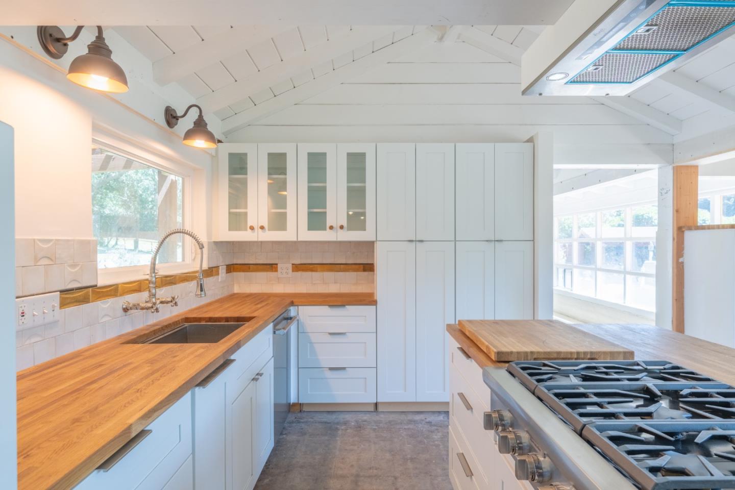 72 Los Laureles Grade Road Carmel Valley, CA 93924 - Photo 10 of 43 a kitchen that has a sink and a stove