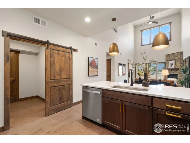 a kitchen with stainless steel appliances granite countertop a sink and a stove