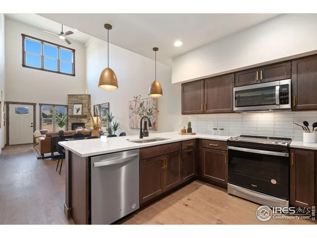 a kitchen with a sink stove and microwave
