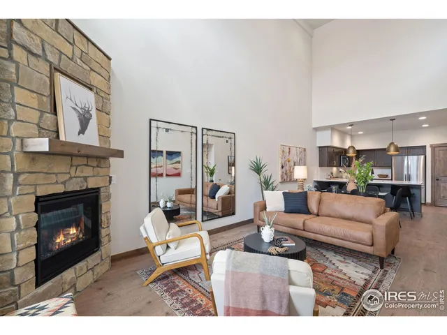 a living room with furniture a fireplace and a wall painting