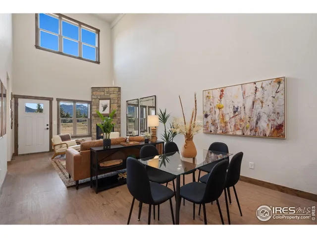 a dining room with furniture and a large window