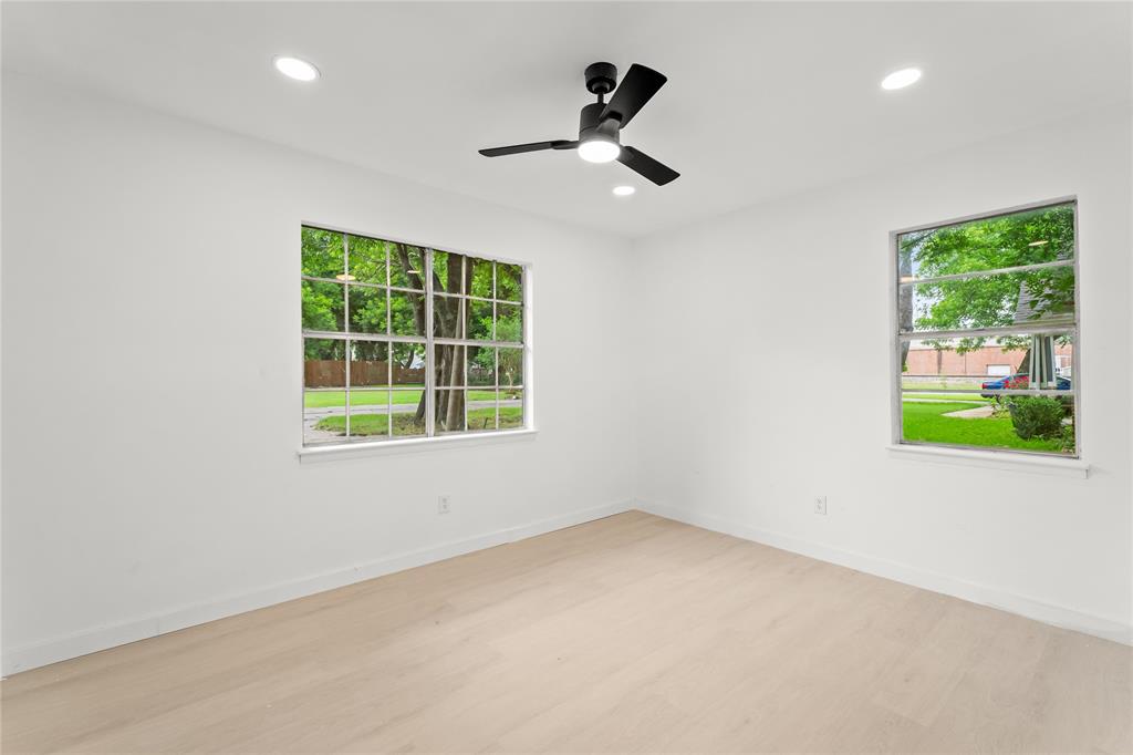 110 Hackberry Street Lancaster, TX 75146 - Photo 17 of 32 Bright interior room featuring wood-finish flooring and white walls