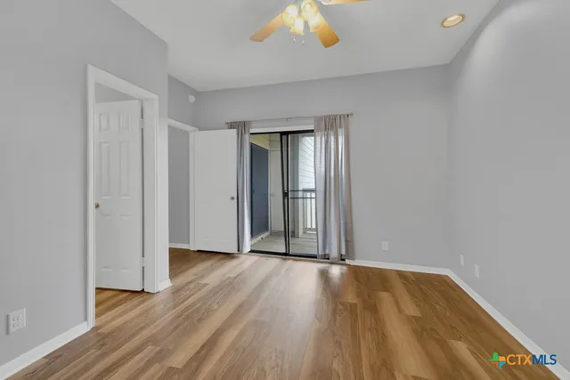an empty room with wooden floor and a window