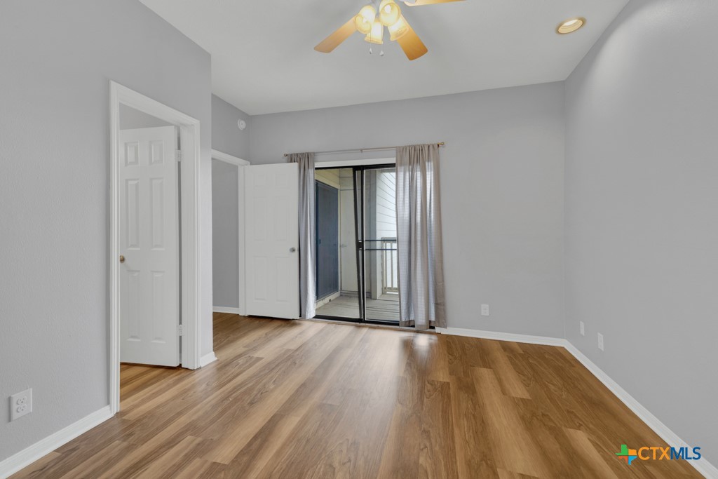 1013 Chestnut Street, Unit D San Marcos, TX 78666 - Photo 12 of 19 an empty room with wooden floor and a window