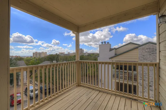 a view of balcony with wooden floor