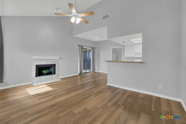 wooden floor chandelier fan and windows