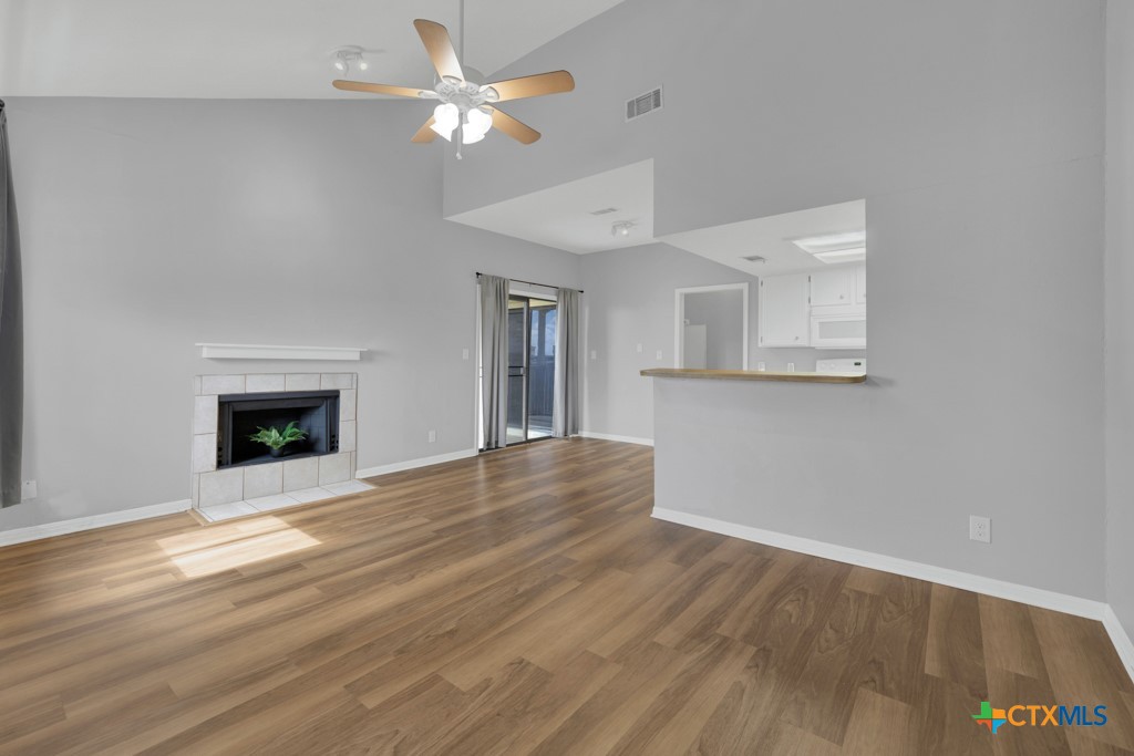 1013 Chestnut Street, Unit D San Marcos, TX 78666 - Photo 3 of 19 wooden floor chandelier fan and windows