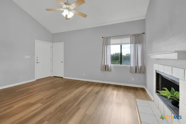 wooden floor in an empty room with a window