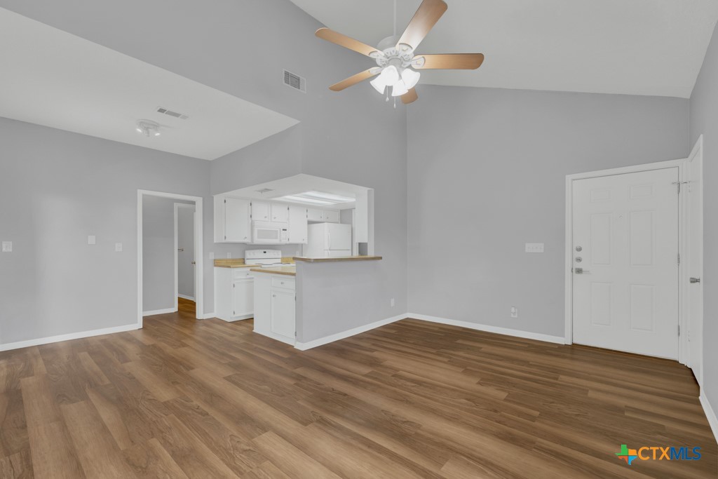1013 Chestnut Street, Unit D San Marcos, TX 78666 - Photo 5 of 19 wooden floor in an empty room with a kitchen