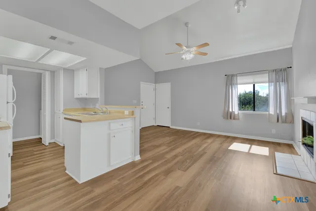 a kitchen with a wooden floor and window