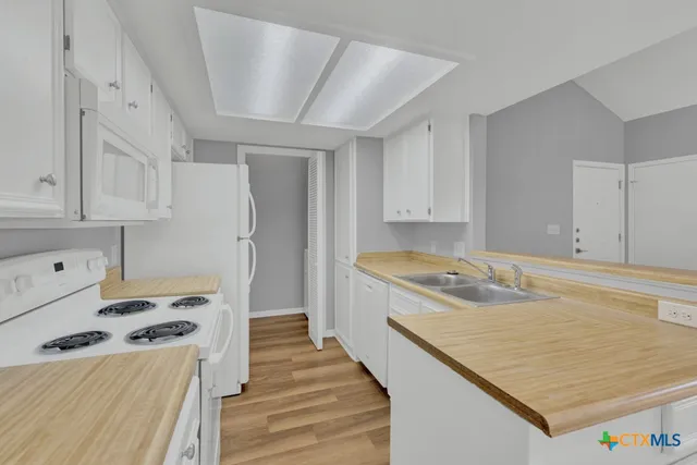 a kitchen with a stove and a refrigerator