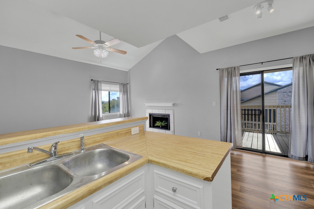 1013 Chestnut Street, Unit D San Marcos, TX 78666 - Photo 10 of 19 a view of a kitchen with a sink and dishwasher with wooden floor